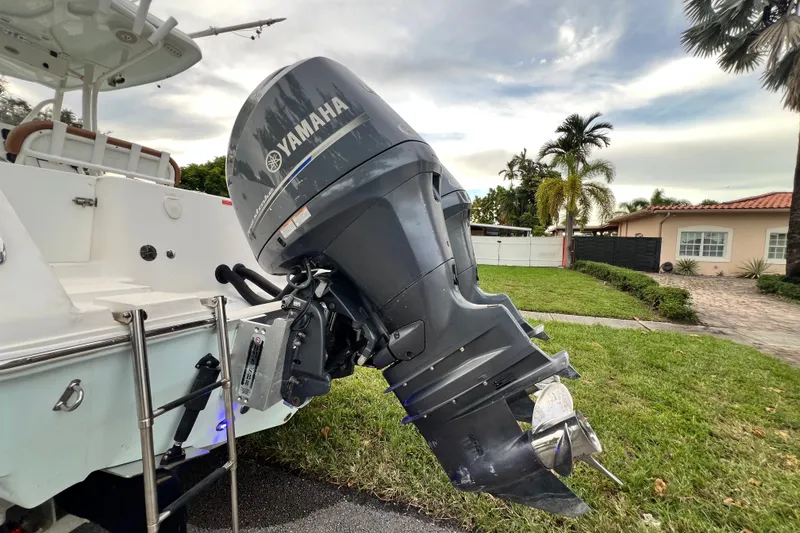 Slide: The Image of 2015 Tidewater 250 CC Adventure with Yamaha outboard motor in a residential setting. - 16