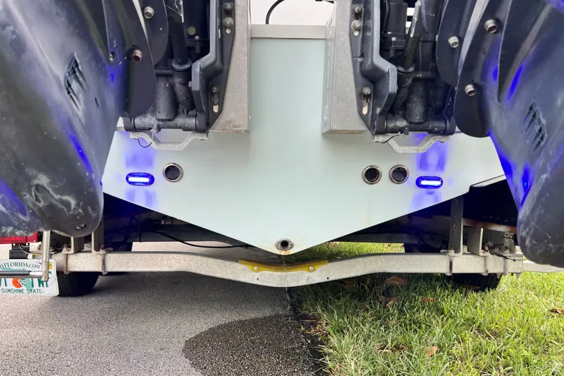 Slide: The Image of Rear view of 2015 Tidewater 250 CC Adventure boat with dual engines and blue lights. - 18