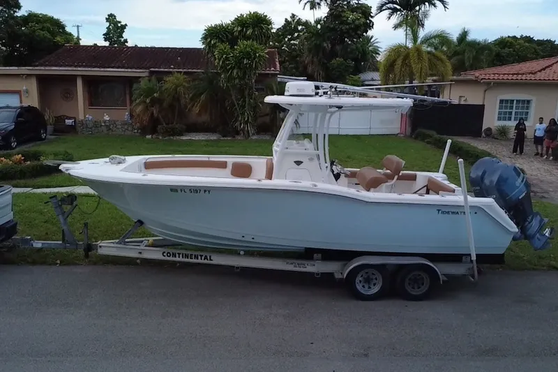 Slide: The Image of 2015 Tidewater 250 CC Adventure boat on trailer in residential area. - 71