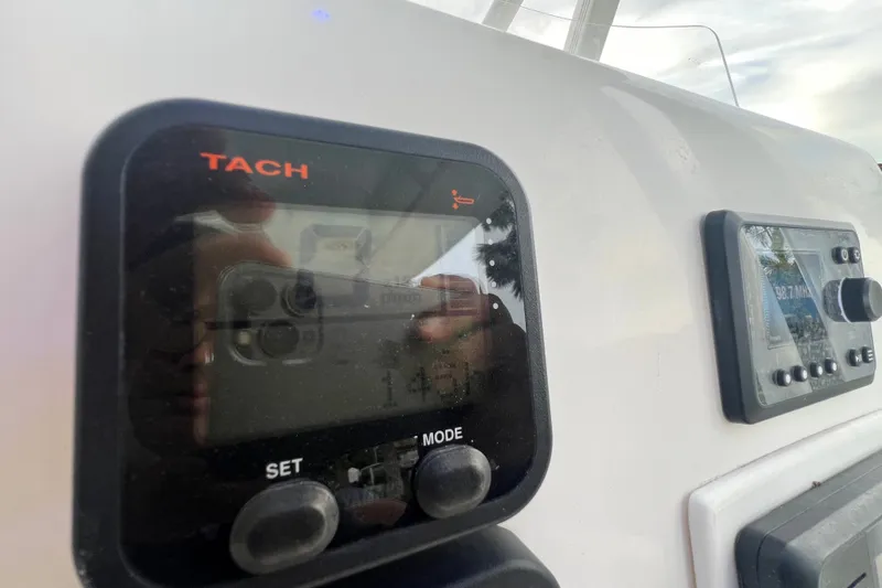 Slide: The Image of Close-up of 2015 Tidewater 250 CC Adventure boat dashboard with tachometer and control panel. - 46