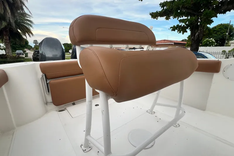 Slide: The Image of 2015 Tidewater 250 CC Adventure boat with tan seating and white deck. - 30