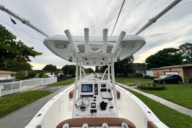 Slide: The Image of 2015 Tidewater 250 CC Adventure boat with advanced navigation system, parked in a suburban neighborhood. - 42