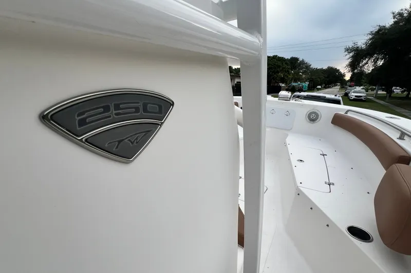 Slide: The Image of 2015 Tidewater 250 CC Adventure boat with sleek interior and emblem detail. - 31