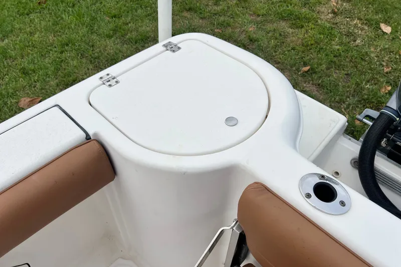 Slide: The Image of 2015 Tidewater 250 CC Adventure boat interior with seating and storage compartment. - 25