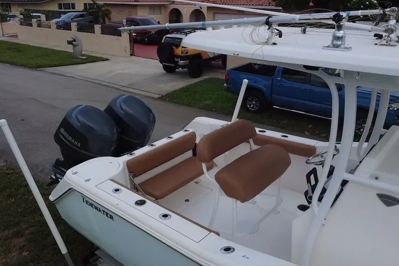 Slide: The Image of 2015 Tidewater 250 CC Adventure boat with Yamaha engines, parked in a residential area. - 78