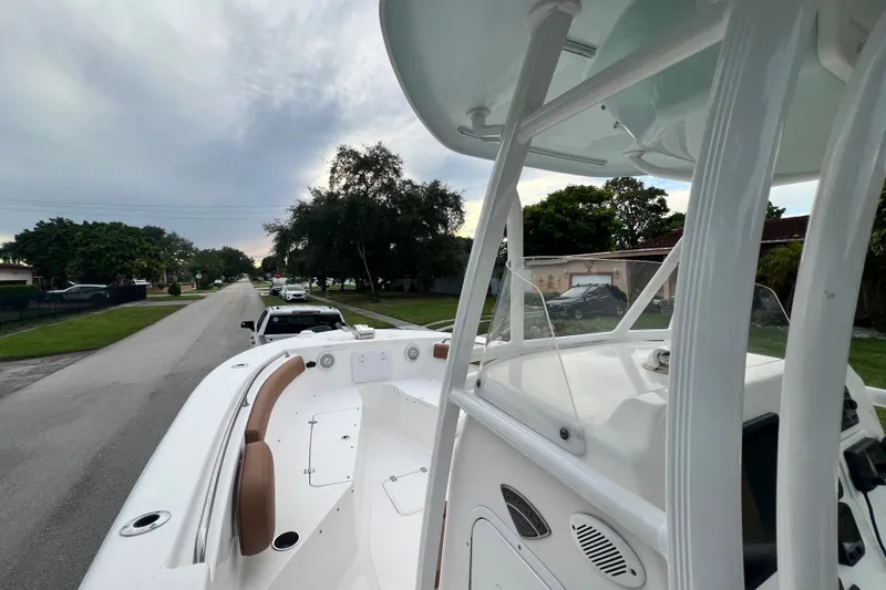 Slide: The Image of 2015 Tidewater 250 CC Adventure boat on a residential street, showcasing its sleek design. - 53