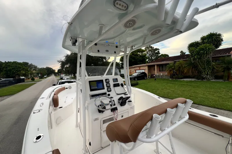 Slide: The Image of 2015 Tidewater 250 CC Adventure boat interior with console and seating on a residential street. - 37