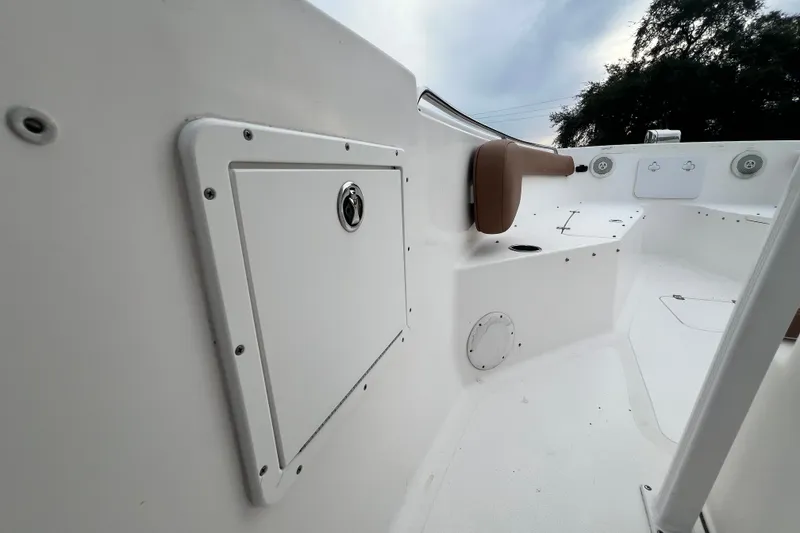 Slide: The Image of 2015 Tidewater 250 CC Adventure boat interior, featuring storage compartment and seating area. - 22