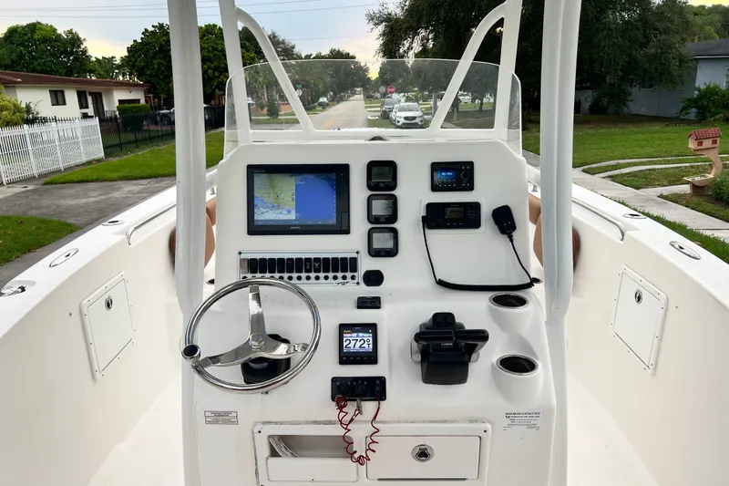 Slide: The Image of 2015 Tidewater 250 CC Adventure boat dashboard with navigation and control systems. - 41