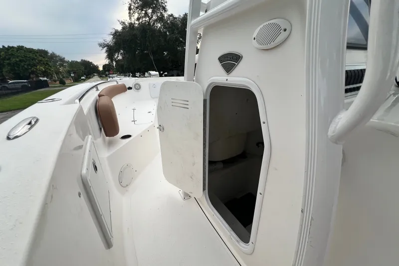 Slide: The Image of 2015 Tidewater 250 CC Adventure boat with open storage compartment and seating. - 50