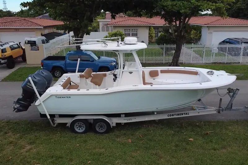 Slide: The Image of 2015 Tidewater 250 CC Adventure boat on trailer, parked in residential area. - 64