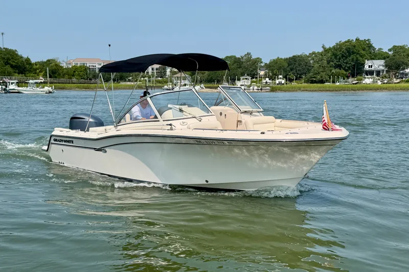 Slide: The Image of 2017 Grady-White Freedom 235 boat cruising on a sunny day in a scenic waterway. - 15
