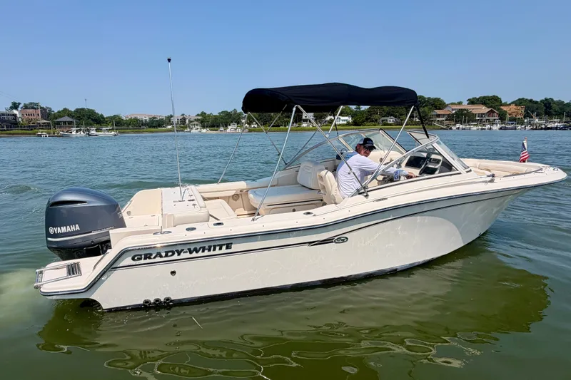 Slide: The Image of 2017 Grady-White Freedom 235 boat on water with Yamaha engine, under clear sky. - 17
