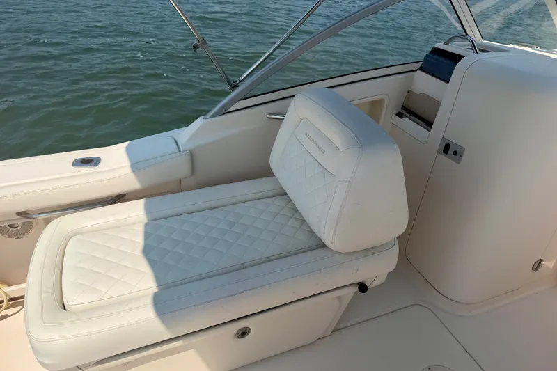 Slide: The Image of 2017 Grady-White Freedom 235 boat interior with cushioned seating and water view. - 31