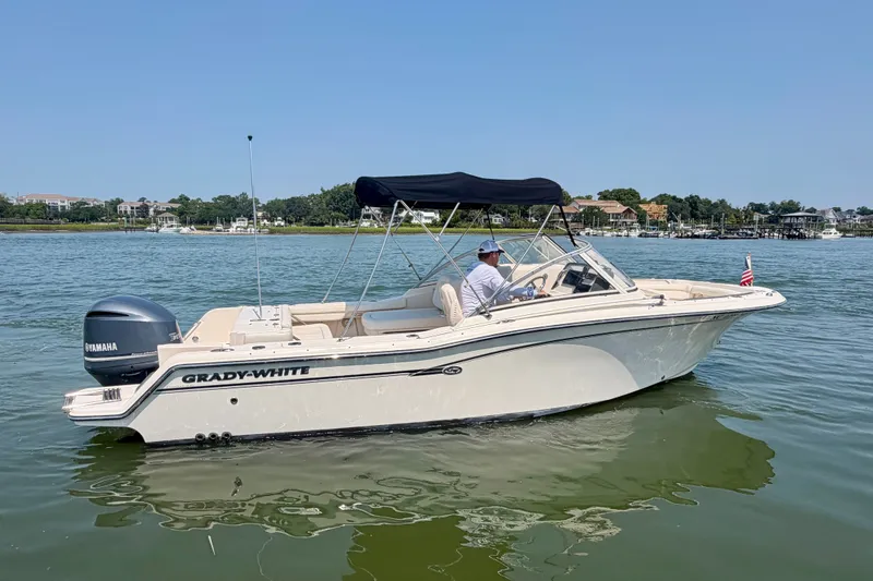 Slide: The Image of 2017 Grady-White Freedom 235 boat on calm water with Yamaha engine. - 16