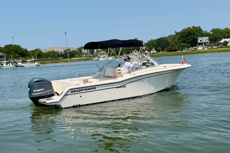 Slide: The Image of 2017 Grady-White Freedom 235 boat cruising on a calm lake with a Yamaha engine. - 2