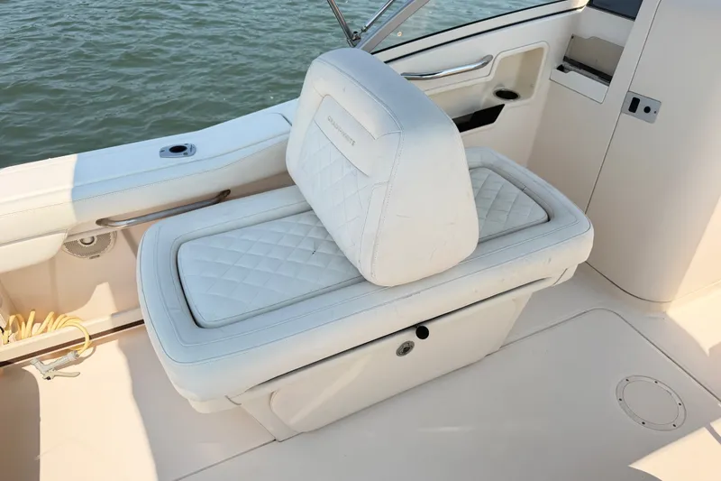 Slide: The Image of 2017 Grady-White Freedom 235 boat seat with white cushioned upholstery. - 43