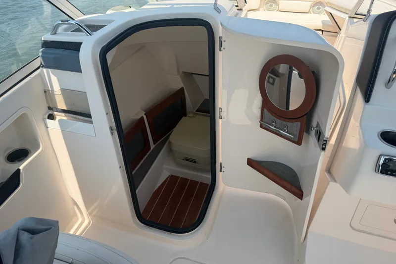 Slide: The Image of 2017 Grady-White Freedom 235 boat cabin interior with open door and mirror. - 37
