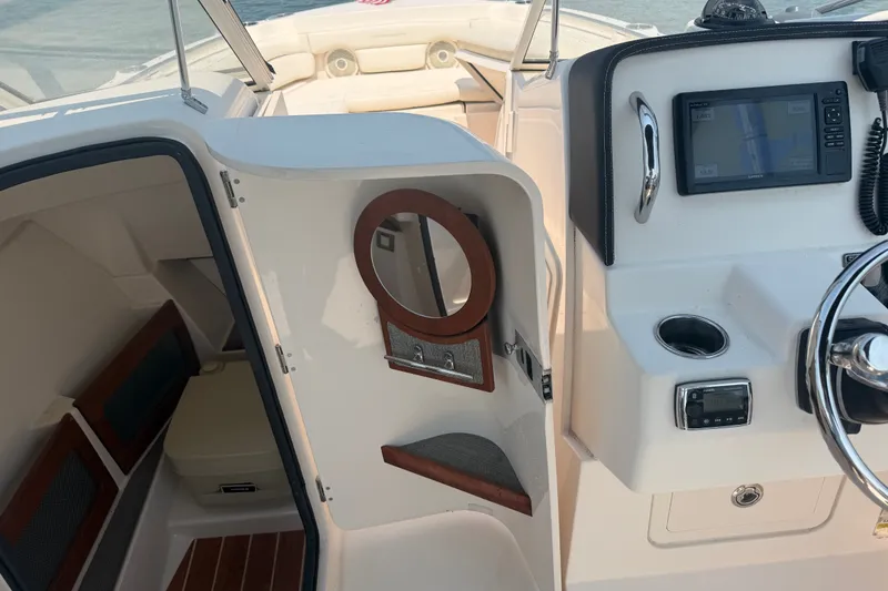 Slide: The Image of 2017 Grady-White Freedom 235 boat interior with helm, seating, and cabin area. - 39
