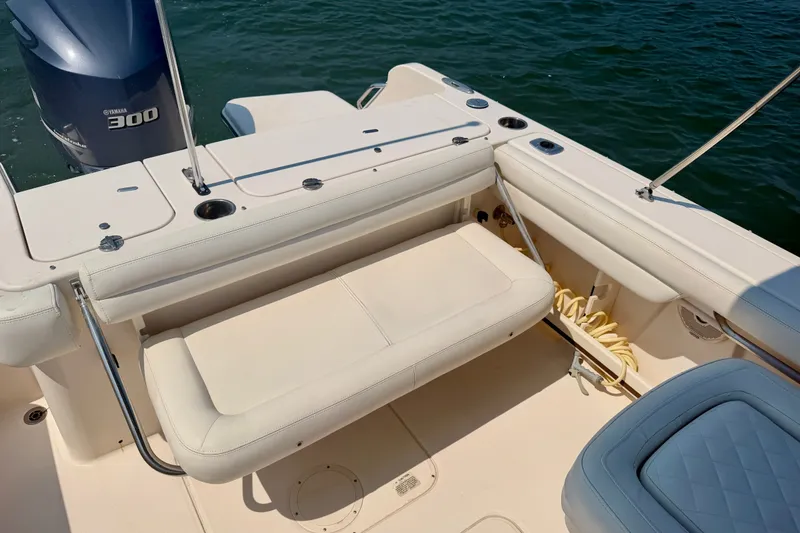 Slide: The Image of 2017 Grady-White Freedom 235 boat interior with Yamaha 300 engine, featuring cushioned seating. - 35
