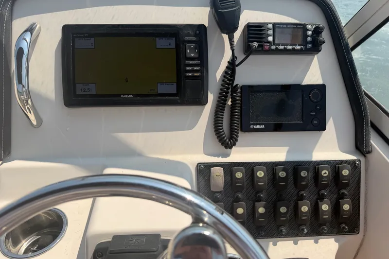 Slide: The Image of Control panel of a 2017 Grady-White Freedom 235 boat with navigation equipment. - 27