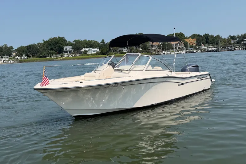 Slide: The Image of 2017 Grady-White Freedom 235 boat on calm water with American flag. - 10
