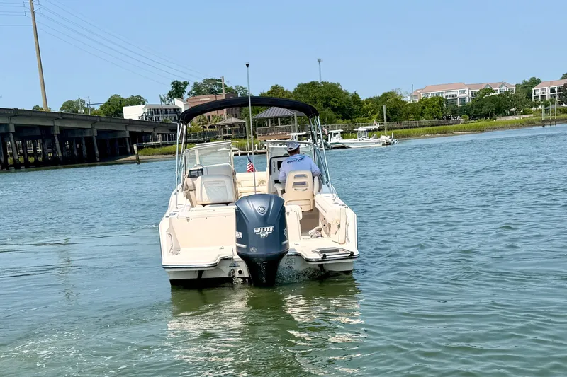 Slide: The Image of 2017 Grady-White Freedom 235 boat cruising on a calm river near a bridge. - 4
