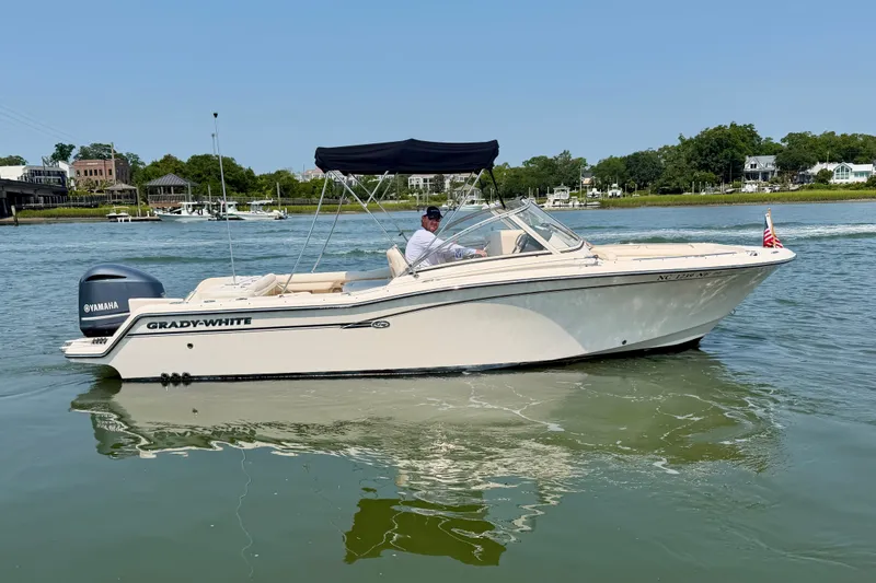 The Image of 2017 Grady-White Freedom 235 boat on calm water with Yamaha engine. - 1