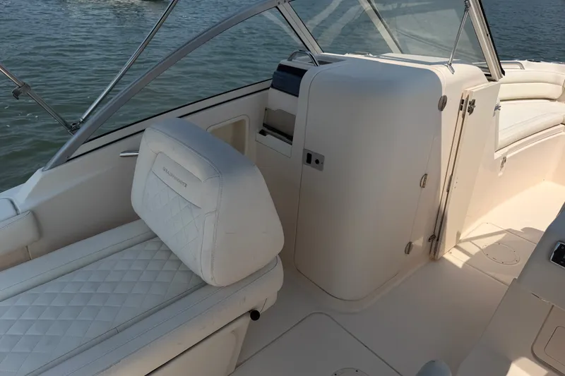 Slide: The Image of 2017 Grady-White Freedom 235 boat interior with cushioned seating and helm. - 32