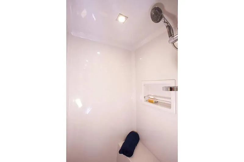 Slide: The Image of Manufacturer Provided Image: 2022 Cruisers Yachts 46 Cantius shower with modern fixtures and built-in shelf. - 13