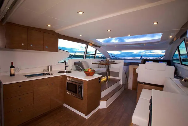 Slide: The Image of Manufacturer Provided Image: Luxurious interior of 2022 Cruisers Yachts 46 Cantius with modern kitchen and seating area. - 7