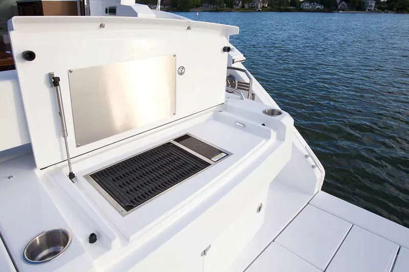 Slide: The Image of Manufacturer Provided Image: Outdoor grill on the 2022 Cruisers Yachts 46 Cantius, overlooking serene waters. - 5