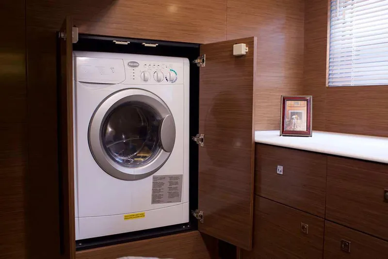 Slide: The Image of Manufacturer Provided Image: Built-in washer in the 2022 Cruisers Yachts 46 Cantius laundry area. - 12
