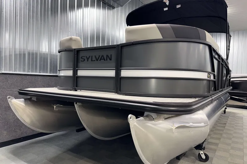 Slide: The Image of 2026 Sylvan L3 CLZ DH Tritoon boat in showroom, featuring sleek design and modern tritoon structure. - 21