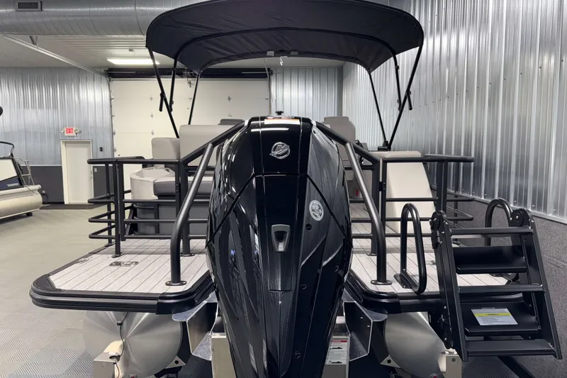 Slide: The Image of 2026 Sylvan L3 CLZ DH Tritoon boat in a metal-walled showroom. - 26