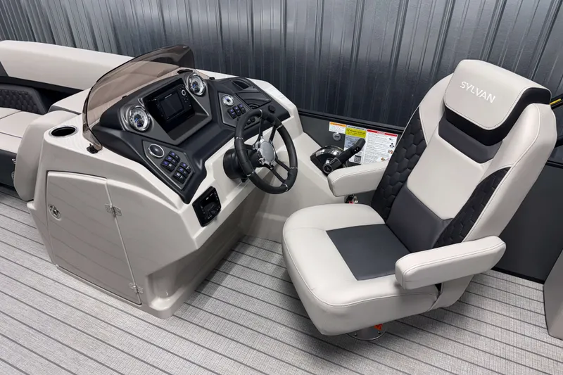 Slide: The Image of Captain's helm of 2026 Sylvan L3 CLZ DH Tritoon with modern controls and plush seating. - 5