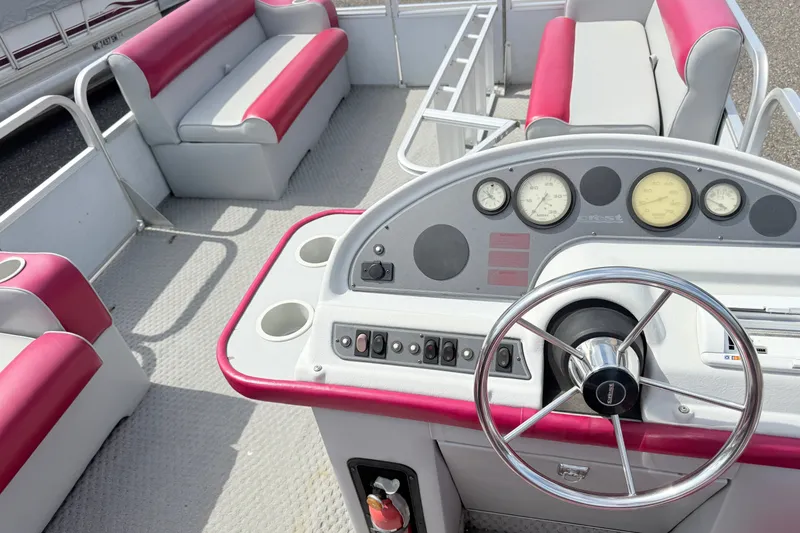 Slide: The Image of 1994 Crest 22 boat interior with red and white seating, steering wheel, and dashboard controls. - 7