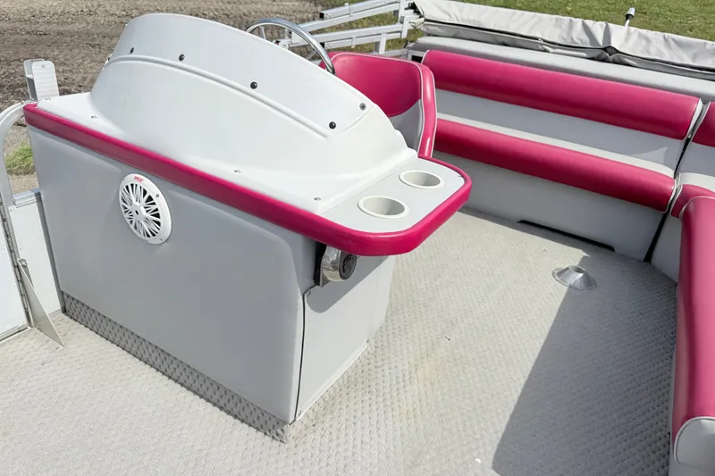 Slide: The Image of 1994 Crest 22 boat interior with red and white seating and steering console. - 11