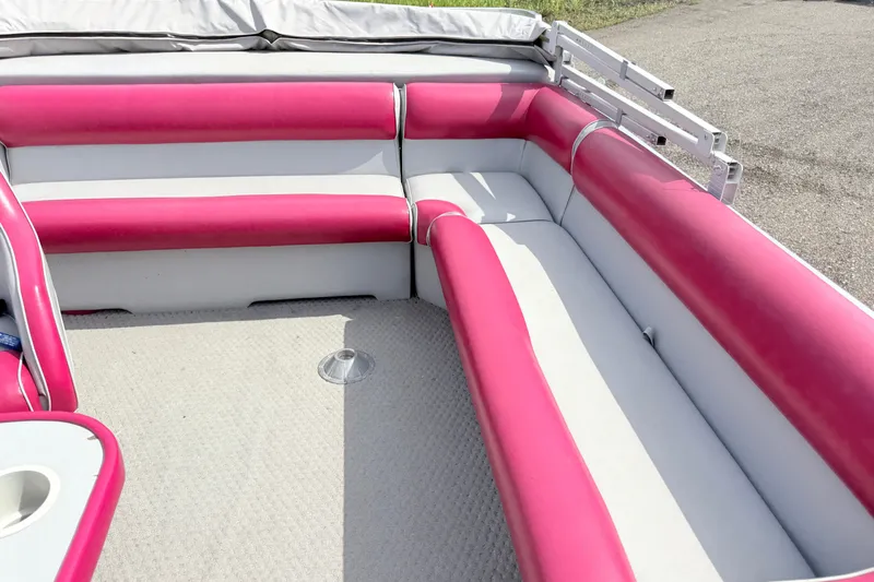 Slide: The Image of 1994 Crest 22 boat interior with pink and white seating, outdoor setting. - 12