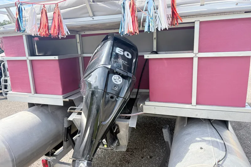 Slide: The Image of 1994 Crest 22 pontoon boat with a 60 HP outboard motor and colorful decorations. - 3