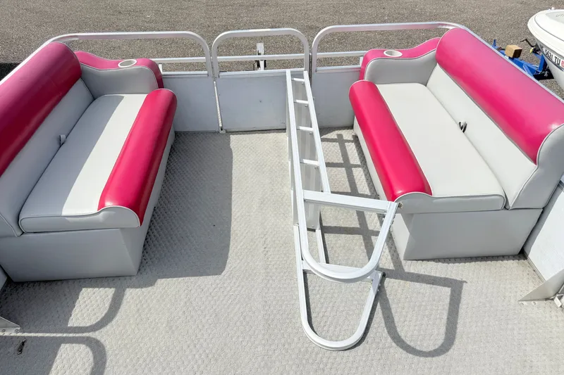 Slide: The Image of 1994 Crest 22 boat interior with pink and white seating, featuring cup holders. - 4