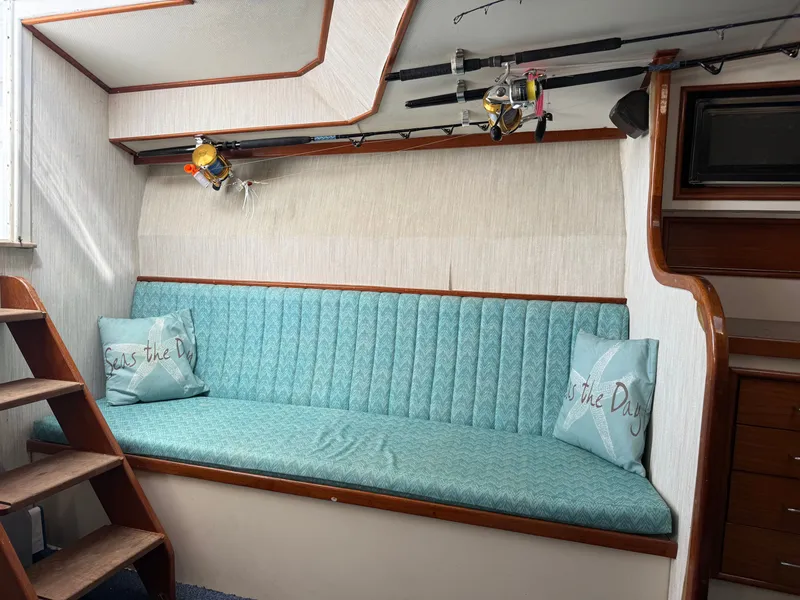 Slide: The Image of Boat interior with turquoise sofa and fishing rod holder on the wall. - 31