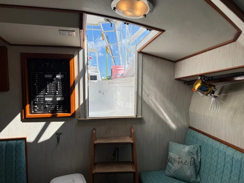 Slide: The Image of The interior of a boat with stairs leading outside. There are seating areas and a cushion. - 39