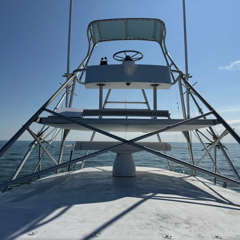 Slide: The Image of A 1993 Custom Gary Davis Carolina boat with an elevated helm station on the ocean. - 14