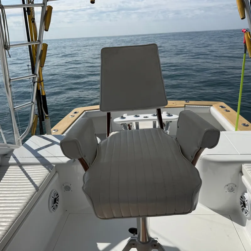 Slide: The Image of A fishing chair on a boat overlooking the open sea. - 24