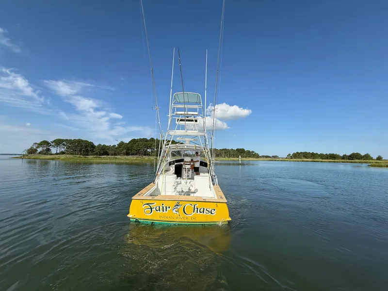 Slide: The Image of A 1993 Custom Gary Davis Carolina boat on calm water with a clear sky. - 8
