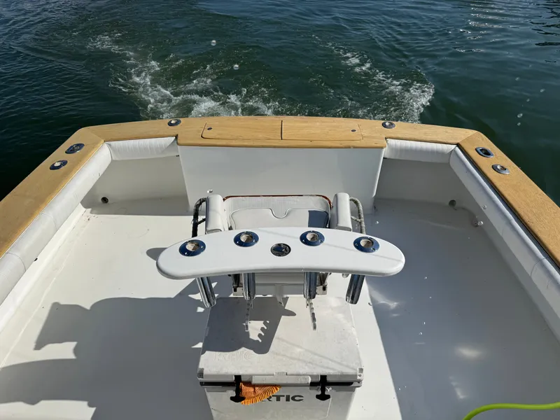 Slide: The Image of The image shows the stern of a boat with a white fishing chair and wooden trim. - 17