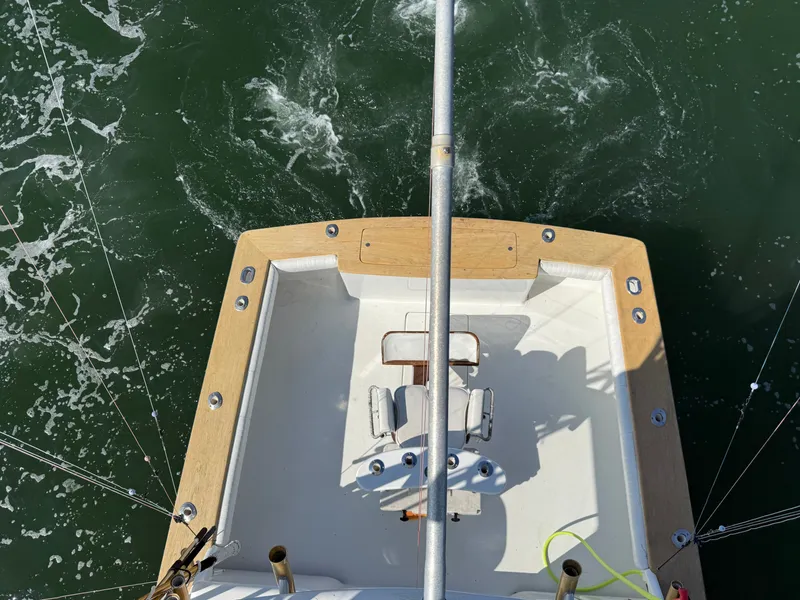 Slide: The Image of The image shows the stern of a boat with a fishing chair and rod holders. - 9