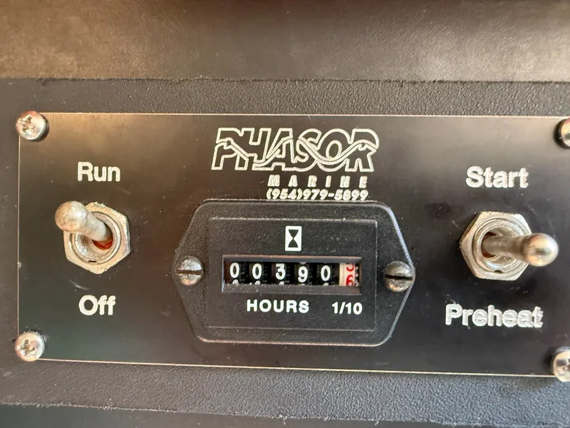 Slide: The Image of Close-up of a Phasor Marine hour meter with toggle switches for start and preheat. - 44