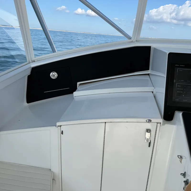 Slide: The Image of The cockpit of a 1993 Custom Gary Davis Carolina with a modern helm area. - 28